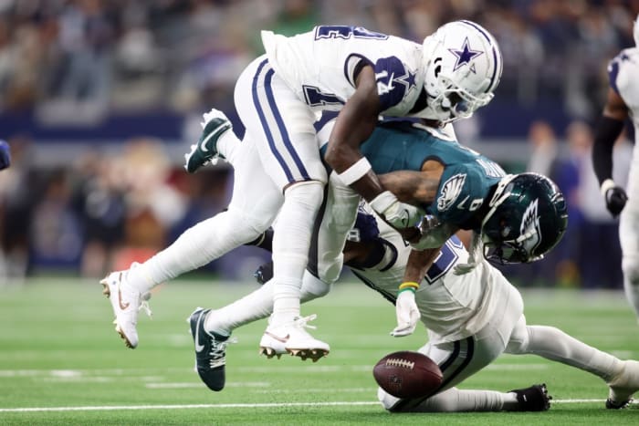 Dec 10, 2023; Arlington, Texas, USA; Philadelphia Eagles wide receiver DeVonta Smith (6) fumbles the ball after being hit by Dallas Cowboys safety Markquese Bell (14) in the fourth quarter at AT&T Stadium.